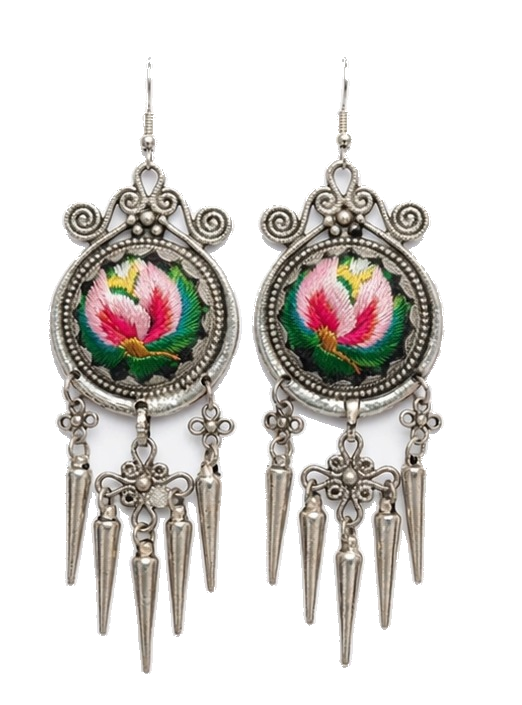 Embroidered floral earrings in ornate silver settings.