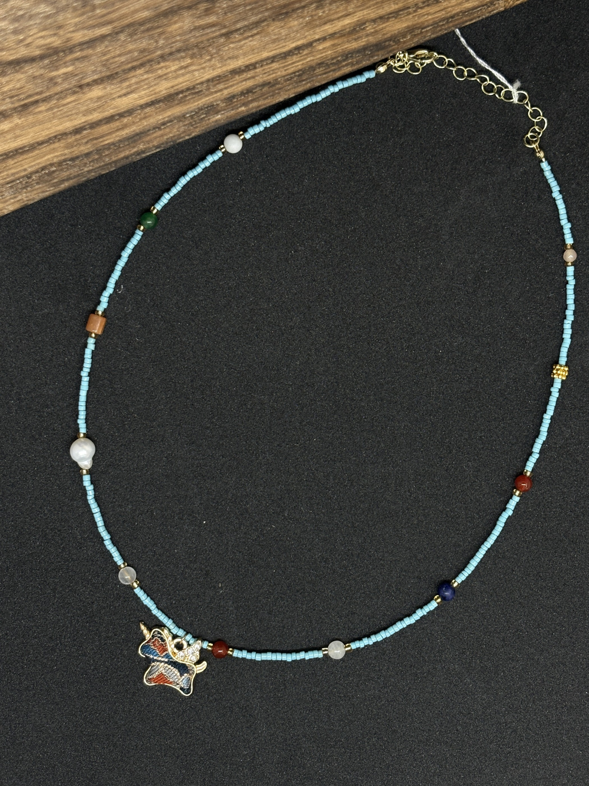 Full view of the turquoise, agate, pearl and jade necklace with Song brocade pendant and clasp.