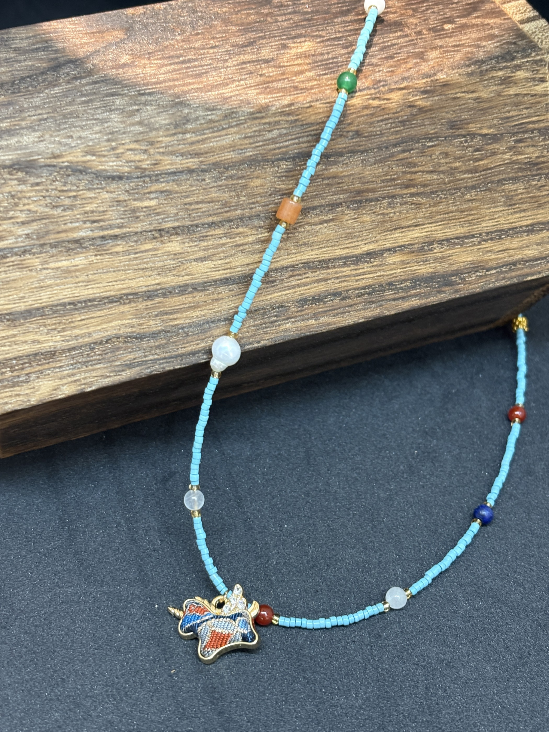 Close view of the blue turquoise beads, contrasting accents, and gold-plated stainless steel separators.