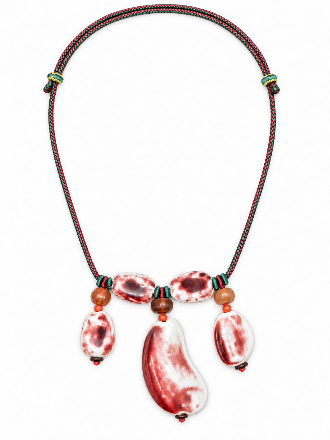 Red and white Jingdezhen ceramic drop necklace on adjustable green and red braided cord.