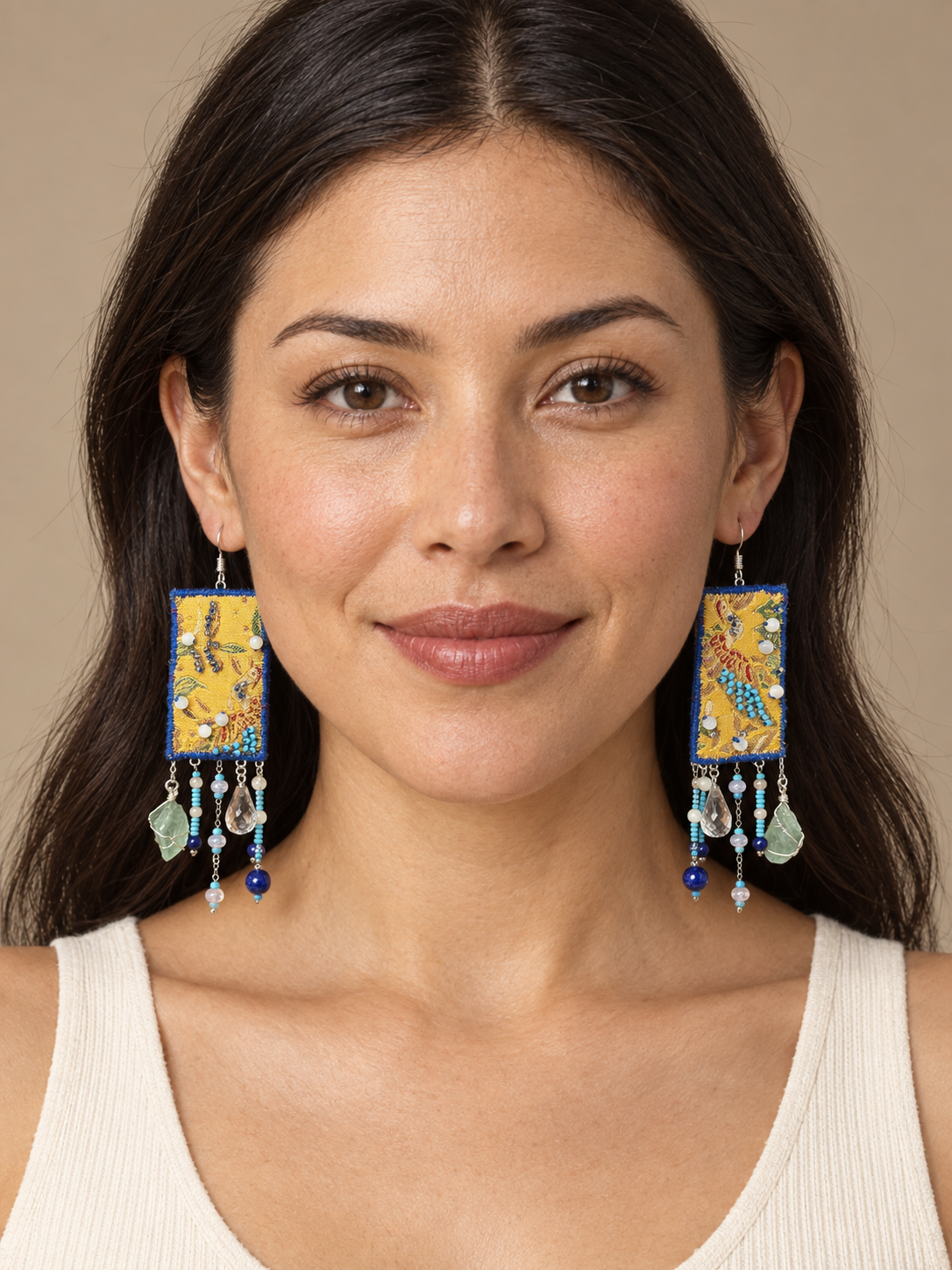 Full-face lifestyle view of a model wearing Inner Adventure Yellow & Blue Cascade Earrings.