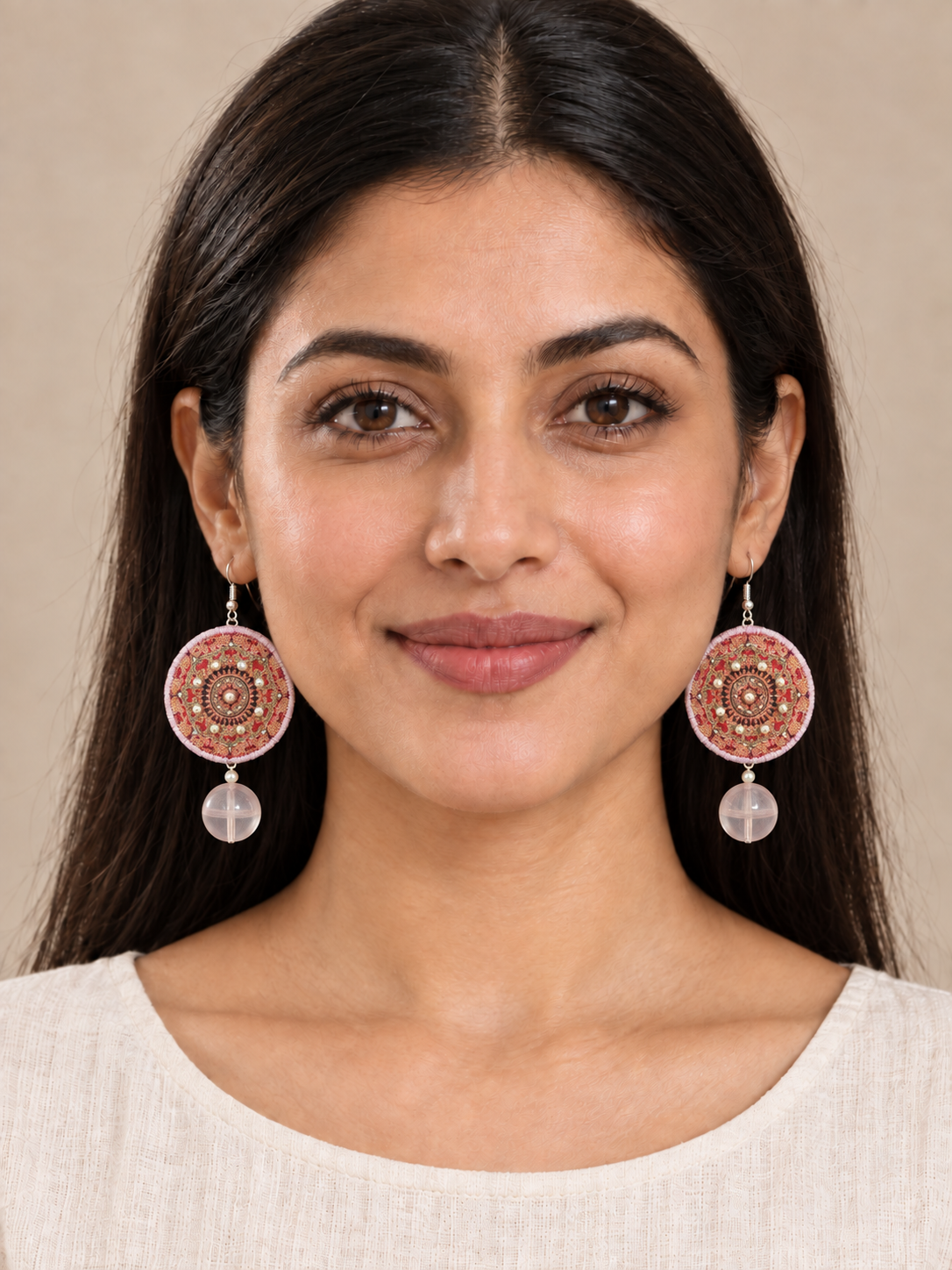 Full-face lifestyle view of a model wearing Inner Adventure Rose Mandala Disc Earrings.