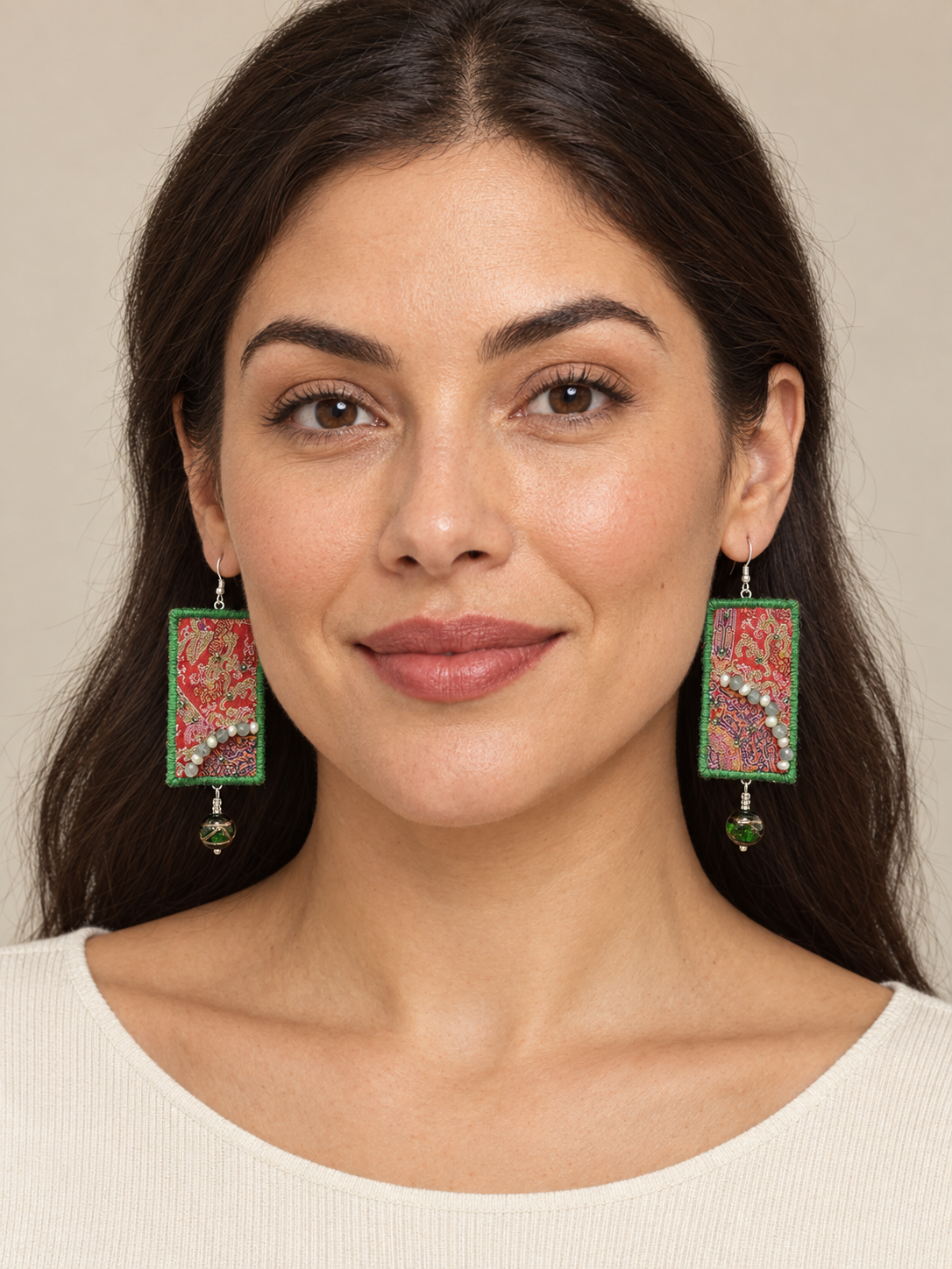 Full-face lifestyle view of a model wearing Inner Adventure Green-Edged Red Textile Earrings.