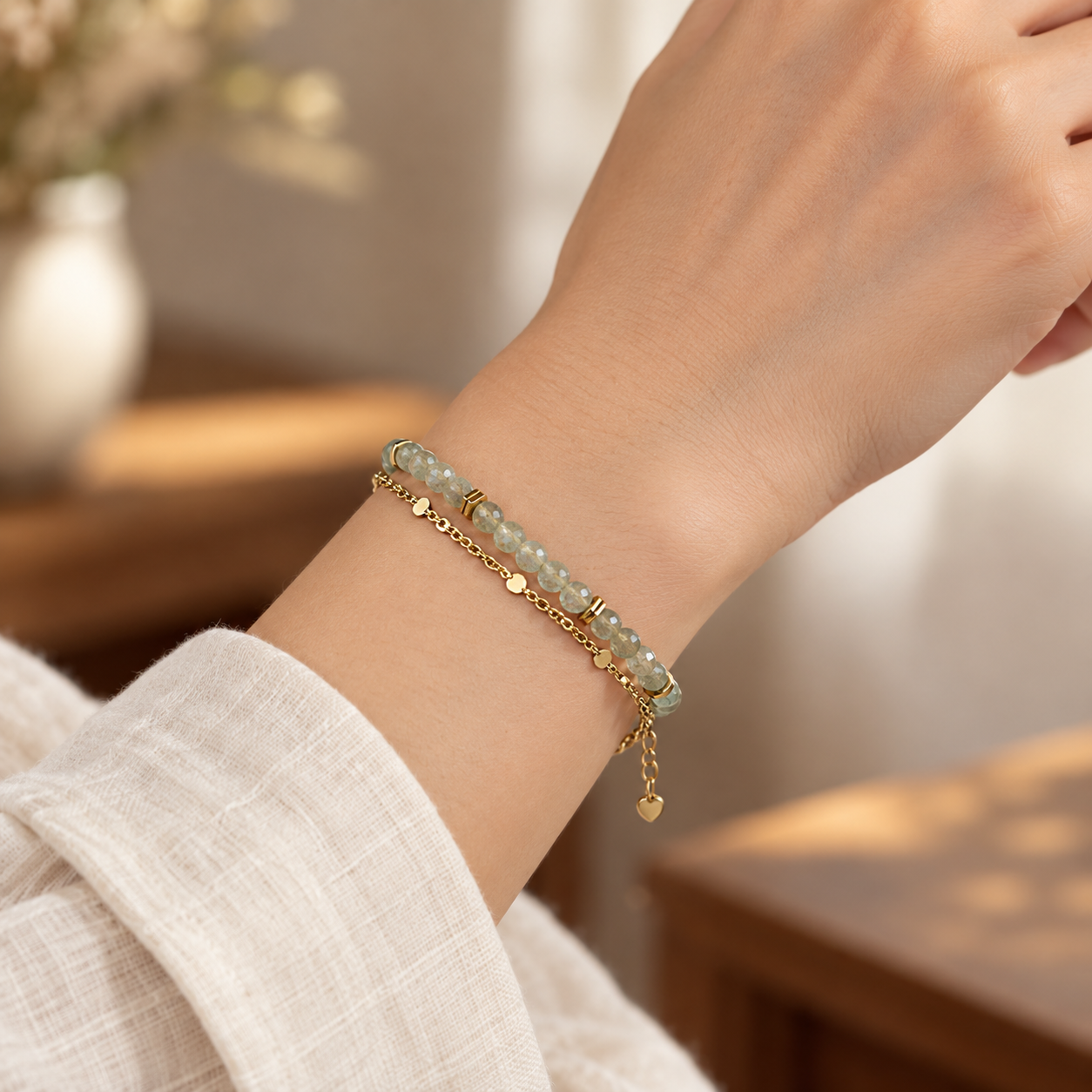 Close wrist view of the pale sage-gray faceted bead double-strand bracelet.