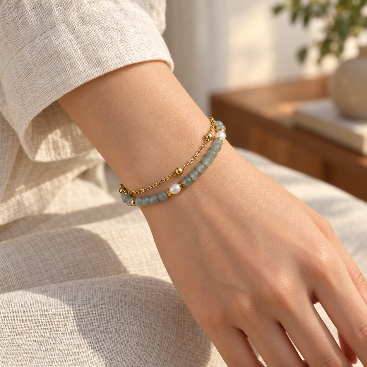 Close wrist view of the mist-gray and white bead double-strand bracelet.