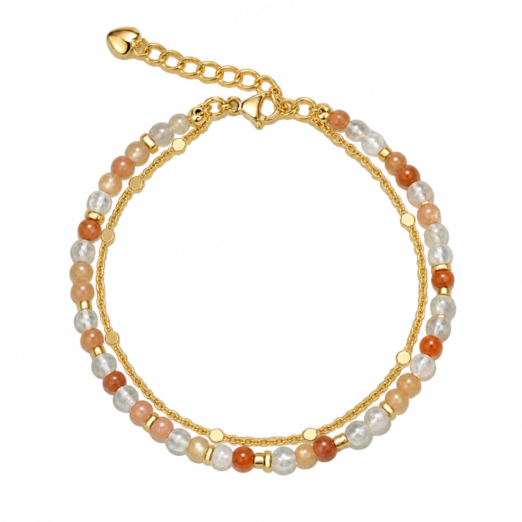Peach, orange and clear bead double-strand bracelet with gold-tone details on white.