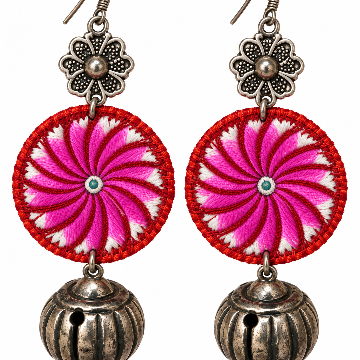 Close detail of the Miao embroidery and silver fittings on the Pink Spiral Miao Embroidery Bell Earrings pair.